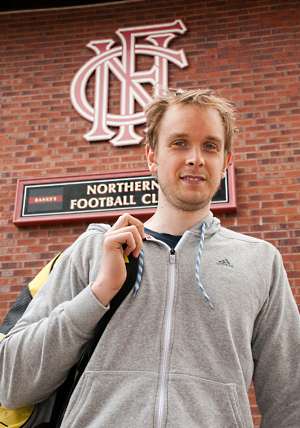 James poses in front of Northern Squash Club